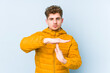 © Asier - Young blond curly hair caucasian man isolated showing a timeout gesture.