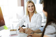 © Iryna - Group of business people discussing questions at meeting. Portrait of blond businesswoman in sunny office