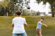 © LIGHTFIELD STUDIOS - selective focus of teenager boy throwing rugby ball to father in park