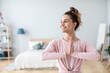 © BestForYou - Young beautiful smiling woman doing yoga exercise in prayer position at home.