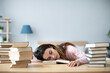 © BestForYou - Young woman student with many books sleeping.