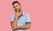 © Krakenimages.com - Handsome man with beard wearing casual clothes looking confident at the camera smiling with crossed arms and hand raised on chin. thinking positive.