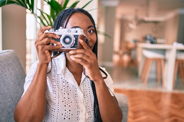 Young african american woman smiling happy using camera at home