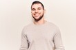 © Krakenimages.com - Young handsome man wearing casual sweater looking positive and happy standing and smiling with a confident smile showing teeth