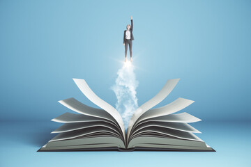 Poster - Businesswoman  flies over open book on blue background.