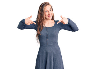 Young beautiful blonde woman wearing casual dress looking confident with smile on face, pointing oneself with fingers proud and happy.