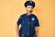 © Krakenimages.com - Middle age hispanic man wearing police uniform making fish face with lips, crazy and comical gesture. funny expression.
