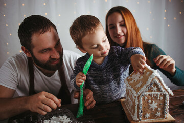 Canvas Print - Family decorating Christmas gingerbread house