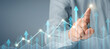 © denphumi - Businessman plan graph growth and increase of chart positive indicators in his business
