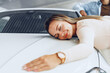 © fotofabrika - Young couple man and woman hugging their new car in a car shop