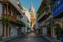 View To The Clock Tower Of Cartagena Cathedral With Blue Sky Through A Narrow Street In Shadow, Cartagena, Colombia, Unesco World Heritage
