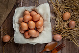 Fototapeta Mapy - Raw Organic Brown Eggs in a Basket