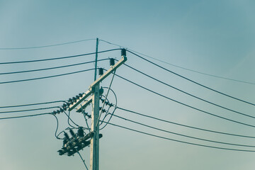 Electric pole of high voltage on blue sky background. Copy space for your text