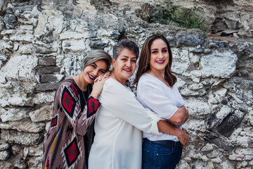 Wall Mural - portrait of hispanic mother with her adult daughters in Mexico