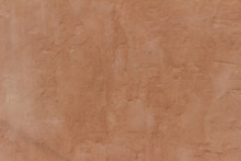 Abstract Background Of An Exterior Reddish Brown Adobe Style Textured Wall Surface