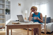 © astrosystem - Woman working from home and being depressed, tired with headache. Modern concept and problems with freelancers.