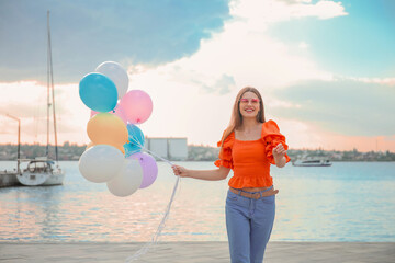 Sticker - Young woman with balloons outdoors near river