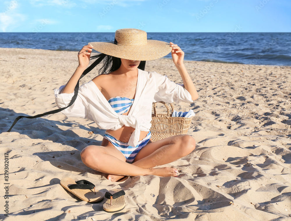 Beautiful young woman on sea beach