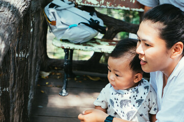 Wall Mural - Shot of Mother and her little son playing together in summer day at the park. Concept of friendly family and vacation