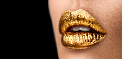 Wall Mural - Golden lipstick closeup. Metal gold lips. Beautiful makeup. Sexy lips, bright paint on beautiful model girl's mouth, close-up. Metallic Lipstick closeup. Isolated on black background