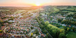 © William - Aerial view of British town set in beautiful countryside in warm light of sunset