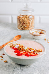 Poster - Healthy banana and strawberrie smoothie in a bowl with pieces of strawberries, granola and coconut chips