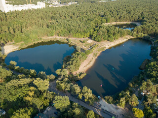 Two lakes in the park among conifers. Aerial drone view.