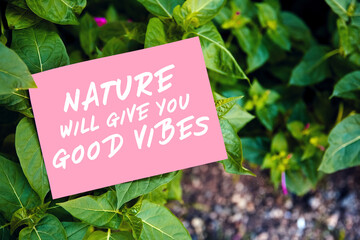 Nature will give you good vibes quote written on paper on green garden and leaf. Inspirational motivational message for orientation with nature in life.