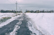 Winter landscape with an ice covered asphalt road in rural village Skelki, Zaporizhia Oblast, Ukraine