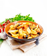 Wall Mural - Pasta penne with eggplant and tomatoes on napkin