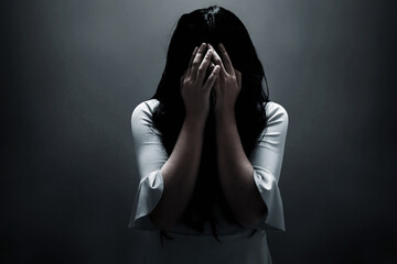 Scared woman on dark background