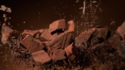 Canvas Print - Super slow motion of flying group of raw chocolate pieces with cocoa powder. Filmed on high speed cinema camera, 1000fps.