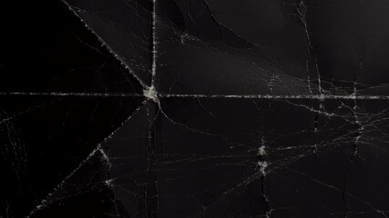 Wall Mural - Grunge abstract black background. A vintage surface with a dusty worn pattern in cracks, spots, dots. Old dark horror style cardboard