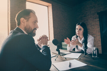 Sticker - Photo of two people colleagues aged businessman business lady journalist press conference ask political questions speak microphone wait answer sit modern office indoors