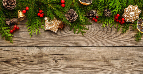 fir tree branches and christmas decorations on wooden background.