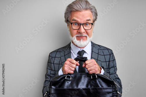 Fotomural greedy senior businessman holding a bag of money, dont's give to someone