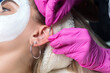 Helix piercing. Ear piercing procedure in the salon
