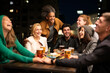 © MandriaPix - group of friends of different ethnicities meeting to toast with pints of beer, focus on afro boy face, friends are smiling and laughing together, millennial people have a party