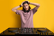 © Roman - surprised man hold head in shock standing in front of dj equipment, doesn't know how to play on it
