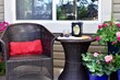 Backyard deck setting with gorgeous landscaped private yard and flowering planters for relaxing on a staycation afternoon with a book for mindfulness time