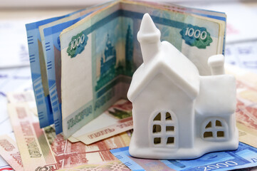 Figurine house on paper money. Russian banknotes and house.