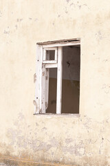 Wall Mural - Window of an old abandoned house. Abstract concrete, weathered with cracks and scratches. Landscape style. Grunge Concrete Surface. Great background or texture.