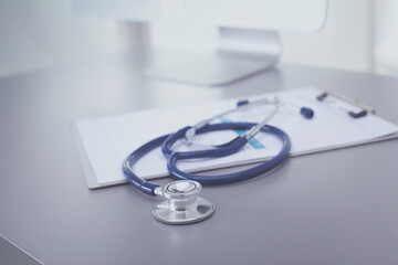 Wall Mural - Medical equipment: blue stethoscope and tablet on white background. Medical equipment