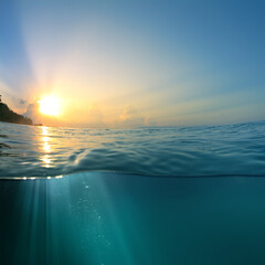 Wall Mural - beautiful sky with the sun image splitted by waterline. air bubbles and sunrays underwater