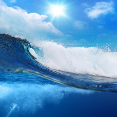 Fototapete - ocean-view seascape landscape Big surfing ocean wave splitted by waterline with slightly cloudy sky and the sun
