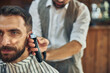 © Viacheslav Yakobchuk - Serious client of a barbershop having his hair trimmed