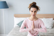 © BestForYou - Attractive young woman working out at home, doing yoga exercise prayer position.