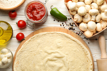 Ingredients for cooking pizza on wooden background