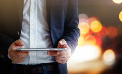 Touch screen in the hands of business people in creative bokeh night light, networking concept