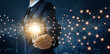 © ipopba - Creativity and idea of business, Businessman holding light bulb with brain inside and icon network connection of marketing on blue city background.